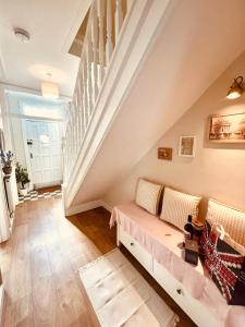 a living room with a couch and stairs at Chic Welsh Escape Character Home in Newport