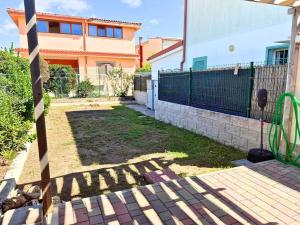 a backyard of a house with a fence at Azure Oasis with parking near the airport & beach in Focene