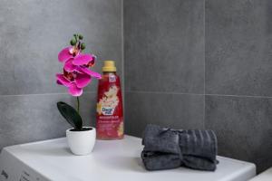 a flower sitting on top of a toilet in a bathroom at Budapest Panoramic Top-Floor Apartment with Citadella & Liberty Statue View in Budapest +30 photos