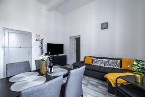 a living room with a couch and a table at Budapest Panoramic Top-Floor Apartment with Citadella & Liberty Statue View in Budapest