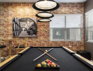 a pool table in a living room with a billiard at Northstar Zen Resort- Rock Waterslide - Pool - Spa - Secret Tunnel - Epic Game Room in Glendale