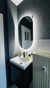a bathroom with a sink and a mirror at 3-room apartment with parking space Sleepomat in Aschaffenburg