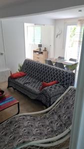 a living room with a couch and a table at Kaz a jolive in Pointe-Noire