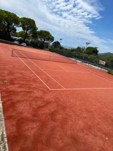 a tennis court with a net on top of it at BIRDS EYE VILLA Luxury Castle Paranomic Views of Monaco Monte Carlo Hills & Sea in La Turbie