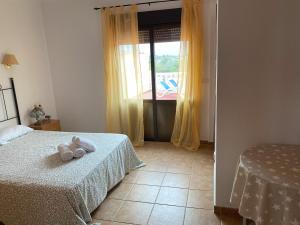 a bedroom with two beds and a window at Villa con encanto en Benimarco in Paratella +10 photos