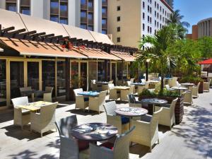 a patio of a restaurant with tables and chairs at Novotel Dakar in Dakar