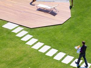 a man walking on the grass with a frisbee at Novotel Lausanne Bussigny in Lausanne
