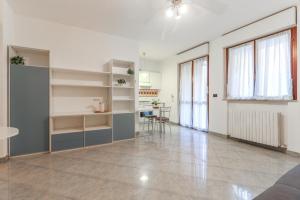 a living room with white shelves and a table at La casetta in Castel Maggiore