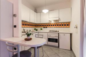 a kitchen with a table and a white counter top at La casetta in Castel Maggiore