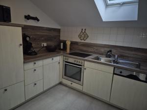 a kitchen with a sink and a stove top oven at Ferienwohnung Ausblick in Bad Wildbad