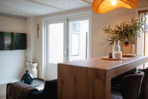 a kitchen with a wooden island in a room at Duijnparadijs in Schoorl