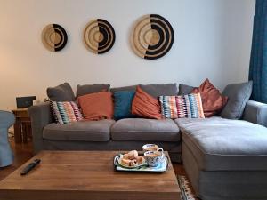 a living room with a couch and a table at All Saints Crescent in Westbury