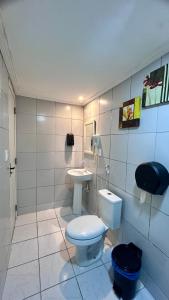 a bathroom with a toilet and a sink at Pousada Praia Boa Viagem in Recife +40 photos