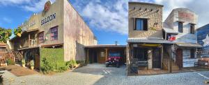 an old building with a sign on the side of it at Pousada Vila do Cowboy in Penha