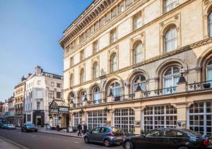 a large building with cars parked in front of it at The Grand Bristol City Center By Dancenter in Bristol