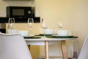 a table with plates and wine glasses on it at 2 Bed Property, Beauly in Beauly