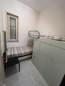 a small room with a bunk bed and a window at Ft apartment in Giardini Naxos