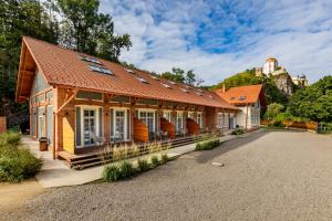 a small house with a roof on a driveway at Benátky 214 in Vranov nad Dyjí