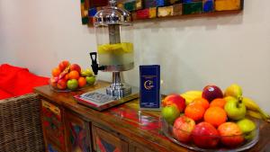 a bowl of fruit on a table with a blender at Dorado Eagle Beach Hotel in Palm-Eagle Beach