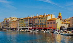 a group of boats docked in a harbor with buildings at Lorette Hideway in Saint-Tropez