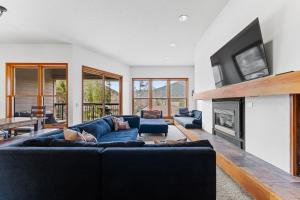 a living room with a couch and a fireplace at Quicksilver 1645 by Summit County Mountain Retreats in Keystone