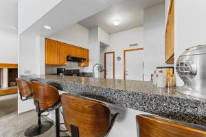 a kitchen with bar stools and a counter top at Quicksilver 1645 by Summit County Mountain Retreats in Keystone