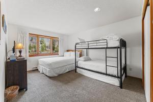 a bedroom with two bunk beds and a window at Quicksilver 1645 by Summit County Mountain Retreats in Keystone +33 photos