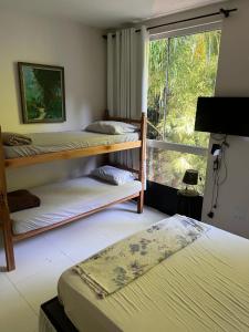 Postel nebo postele na pokoji v ubytování Foresthouse Beach Hostel