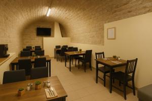 a restaurant with tables and chairs and a brick wall at Résidence Chlorophylle - Arcueil in Arcueil