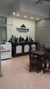 a restaurant with a table and chairs in a room at Hotel Raglan in Mar del Plata