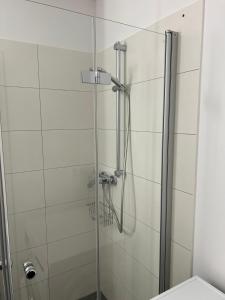 a bathroom with a glass shower with a toilet at NEU - Apartment in Brühl-City in Brühl
