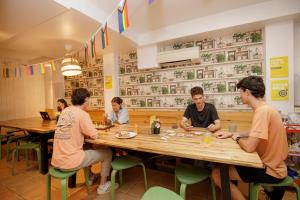 a group of people sitting around a table in a restaurant at Onefam Batlló in Barcelona