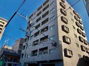 a tall building with windows on the side of it at Blue Eyes Chuo - Vacation STAY 16693 in Kagoshima