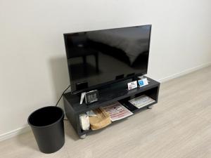 a flat screen tv on a stand with a trash can at M,ULTRA - Vacation STAY 16696 in Kagoshima +3 photos