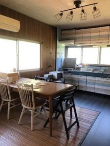 a kitchen and dining room with a table and chairs at KuraKura Village - Vacation STAY 39459v in Kami-ichi