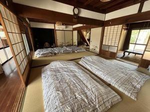 two large beds in a room with windows at KuraKura Village - Vacation STAY 39459v in Kami-ichi