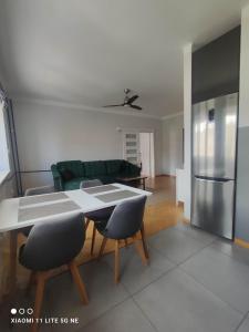 a living room with a table and a green couch at Warsaw Shire in Warsaw