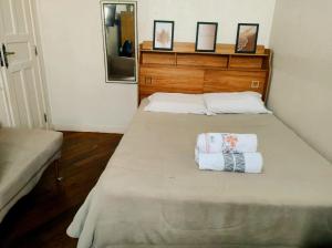 a bedroom with a bed with two towels on it at casa santos cop 30 in Belém
