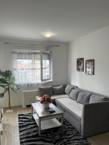 a living room with a couch and a table at Elly in Modriča