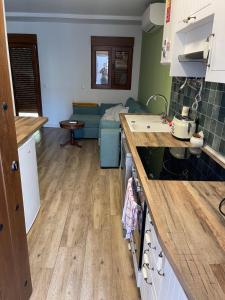 a kitchen and living room with a blue couch at Apartamento Robledo de Chavela Plaza 1A in Robledo de Chavela +5 photos