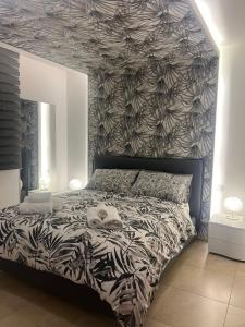 a bedroom with a bed with a black and white patterned wall at B&B Dream House in Campobasso