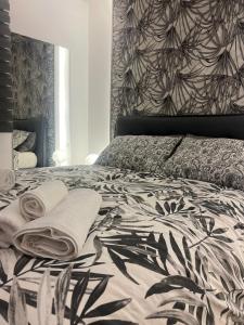 a bedroom with a bed with a black and white bedspread at B&B Dream House in Campobasso