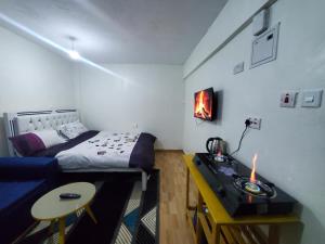 a bedroom with a bed and a desk with a candle at Royal Nest in Rungiri