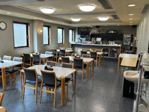 a restaurant with tables and chairs and a counter at Hotel Tetora Hachinohe - Vacation STAY 12735v in Hitoichi