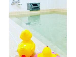 two rubber ducks sitting next to a swimming pool at Hotel Tetora Hachinohe - Vacation STAY 12756v in Hitoichi