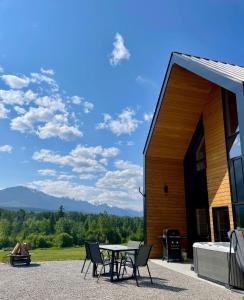 a patio with a table and chairs in front of a building at Pur Lodging Mountain Cabin 1 - Private Hot Tub in Golden
