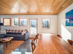 a living room with a wooden table and a couch at Pur Lodging Mountain Cabin 1 - Private Hot Tub in Golden
