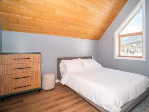 a bedroom with a bed and a wooden ceiling at Pur Lodging Mountain Cabin 3 - Private Hot Tub in Golden