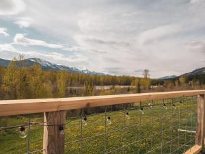 a view from the deck of a farm with chickens in a field at Maple Ranch Tiny House- Private Hot Tub in Golden