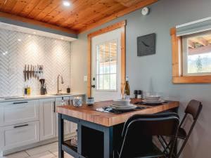 a kitchen with a wooden island in the middle at Maple Ranch Tiny House- Private Hot Tub in Golden